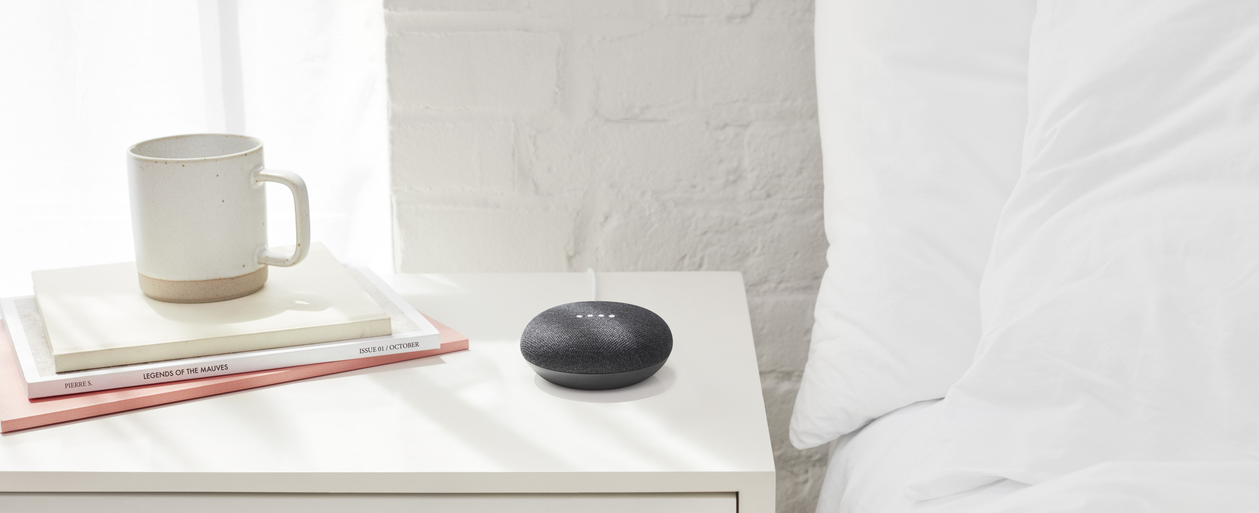 A Google nest mini on a bedside table