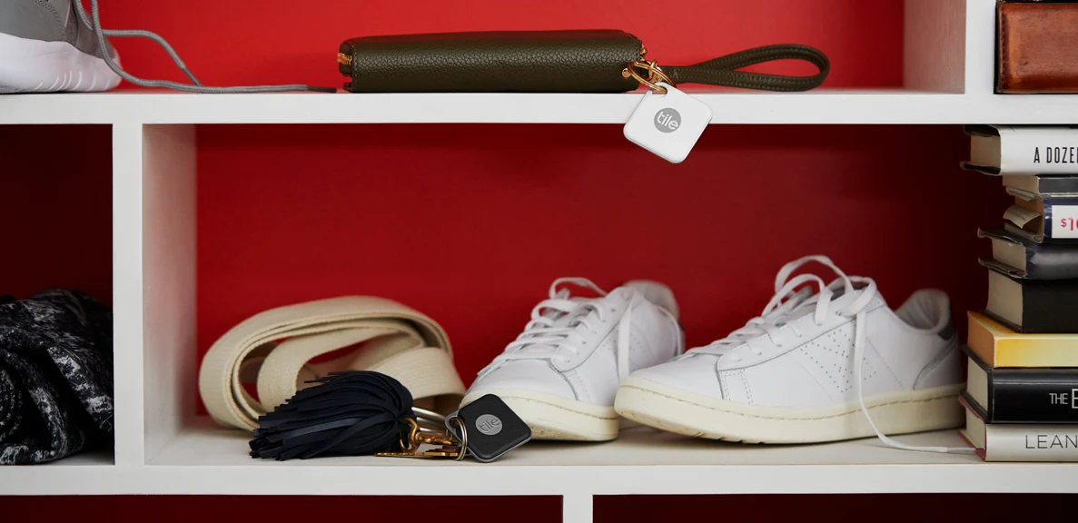 A storage shelf with a wallet with a Tile attached