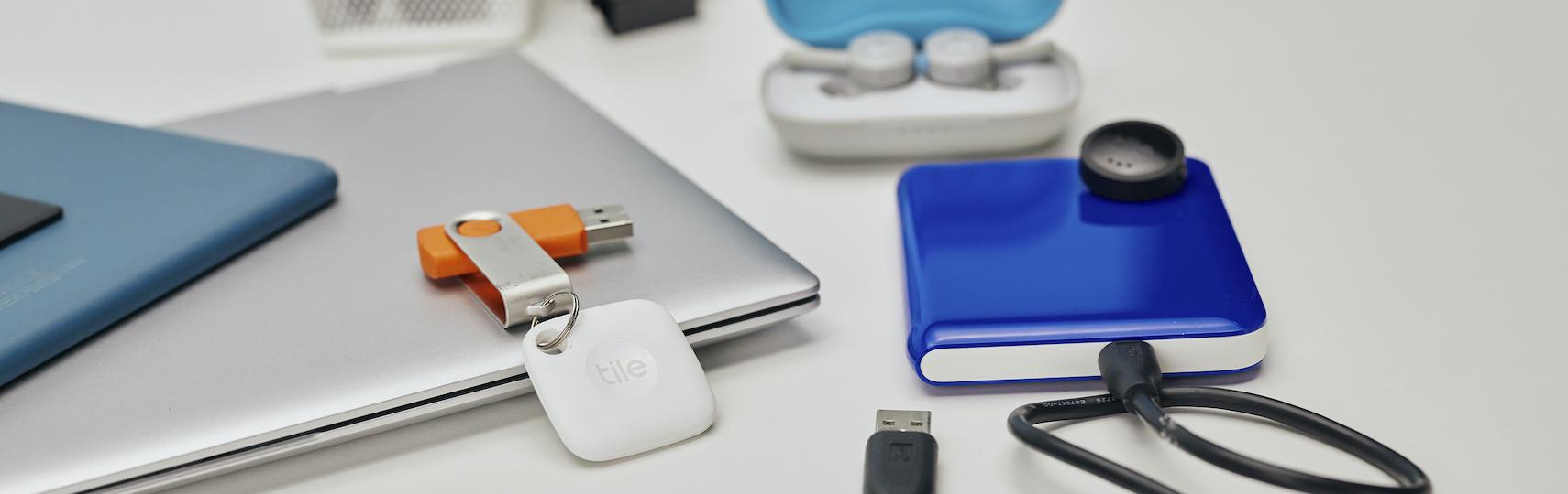 A Tile mate attached to a USB key and a tile sticker on a portable USB drive