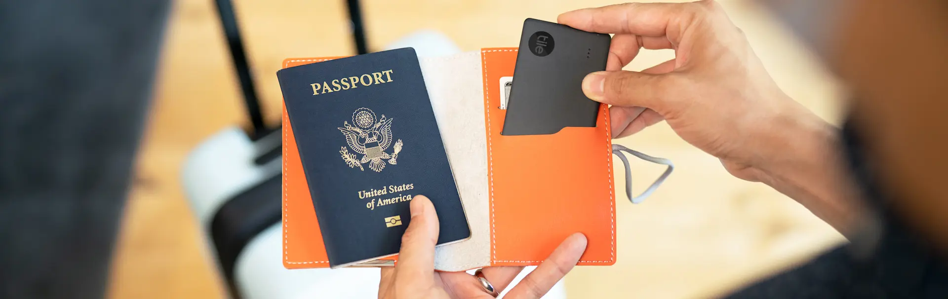 A passport holder with a Tile in it