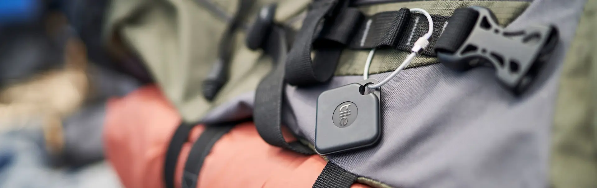 A Tile mate attached to a backpack