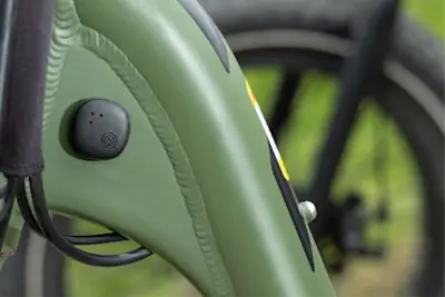 A Life360 Tile Sticker - Black placed on the back seat of a bicycle.
