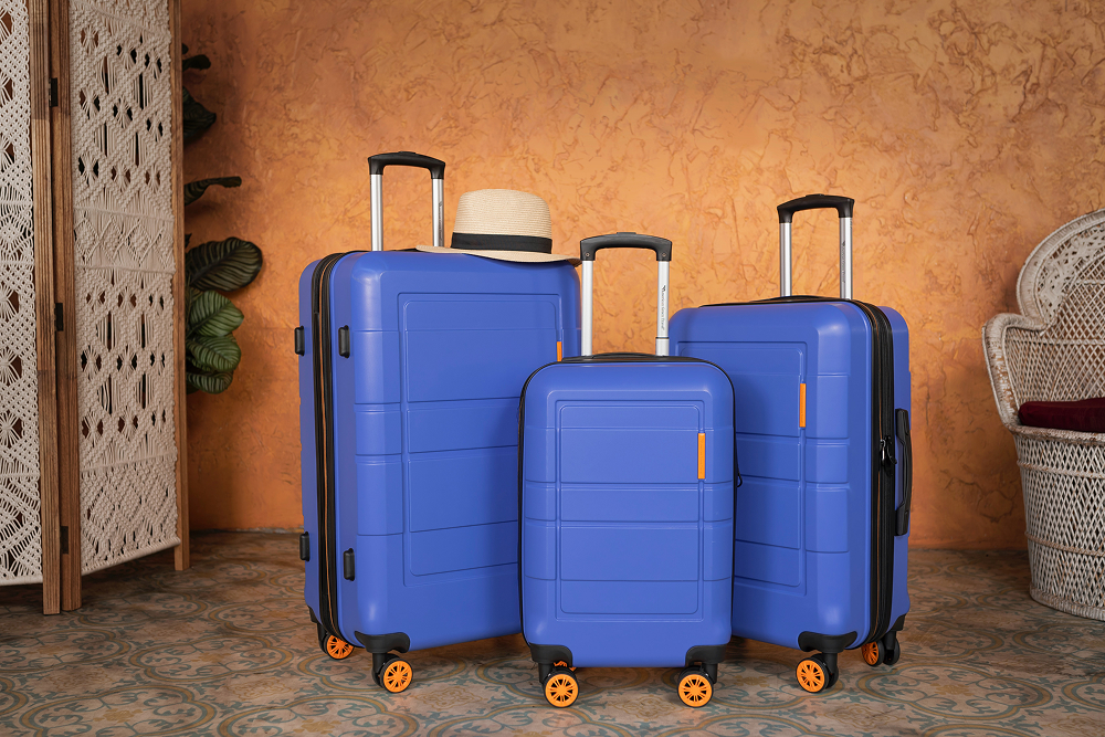 Three blue hardshell suitcases