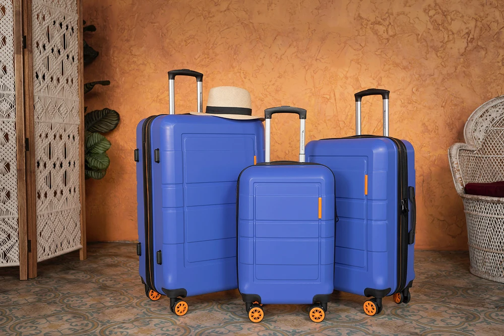 Three blue hardshell suitcases