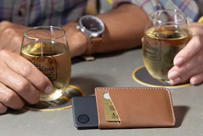 A Life360 Tile Slim inside of a card holder.