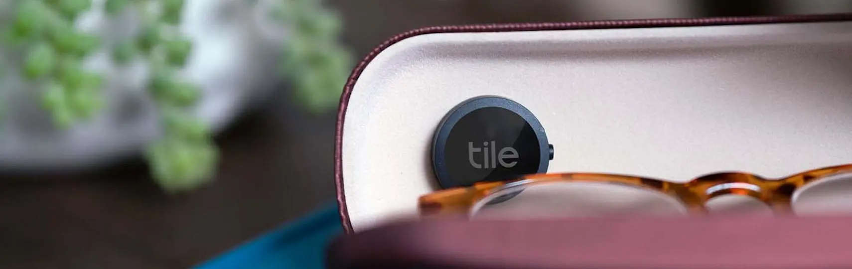 A Tile sticker attached to someone's glasses case