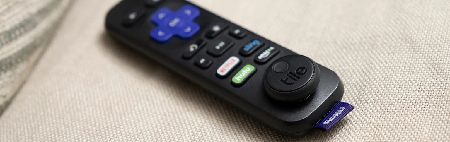 A remote with Tile sticker attached