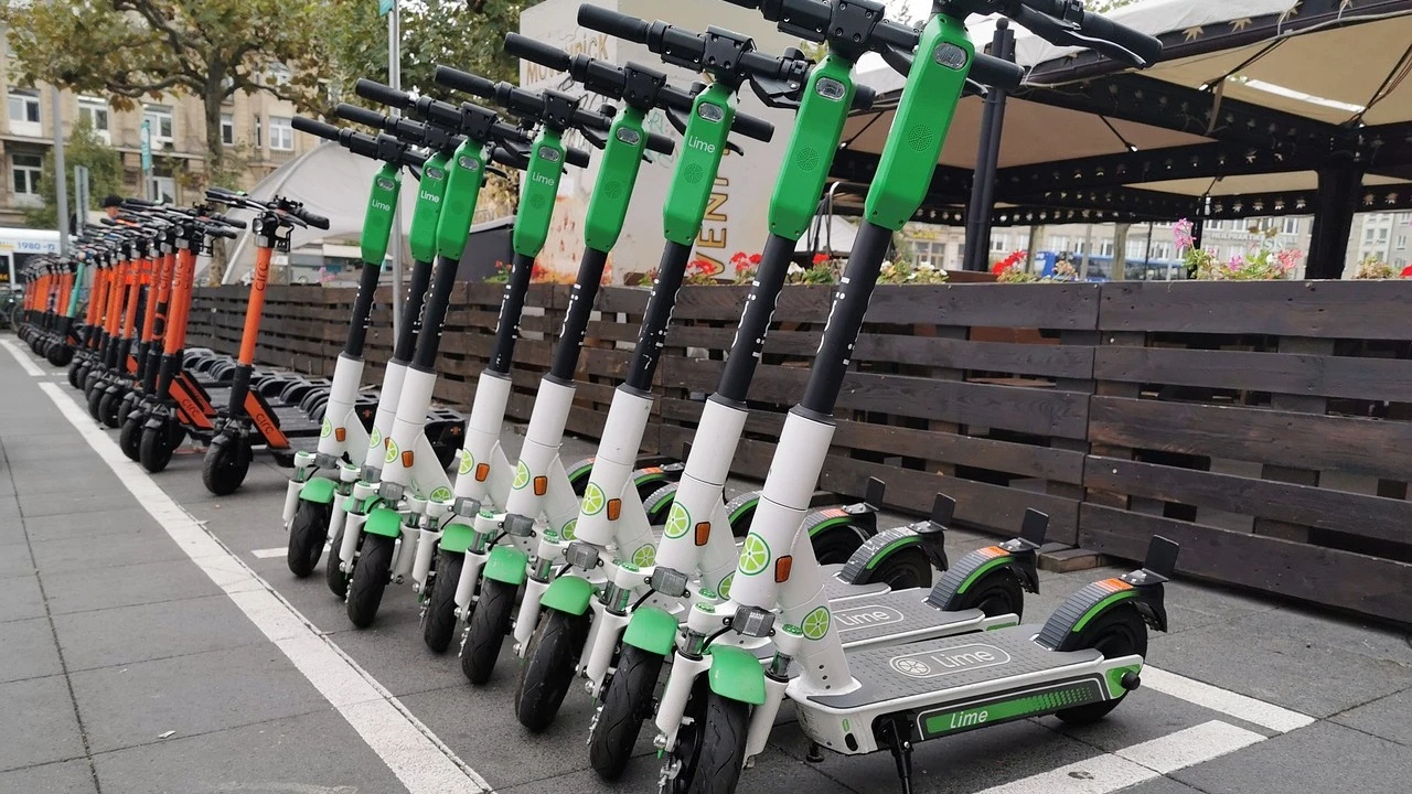 Lime e-scooters lined up on sidewalk