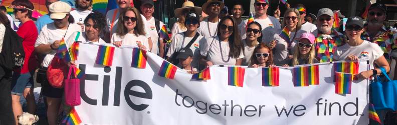 Tile employees with a Pride banner