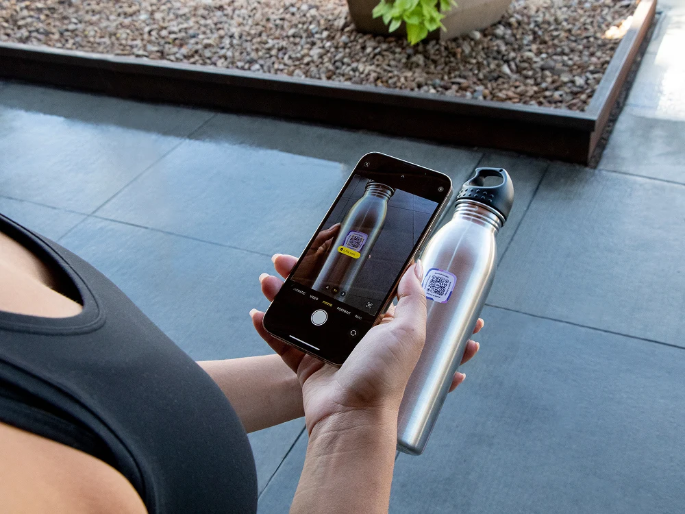 Woman scanning the quadro label on her water bottle