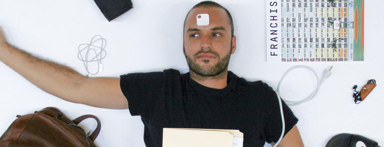 A person lying down with a Tile on their forehead