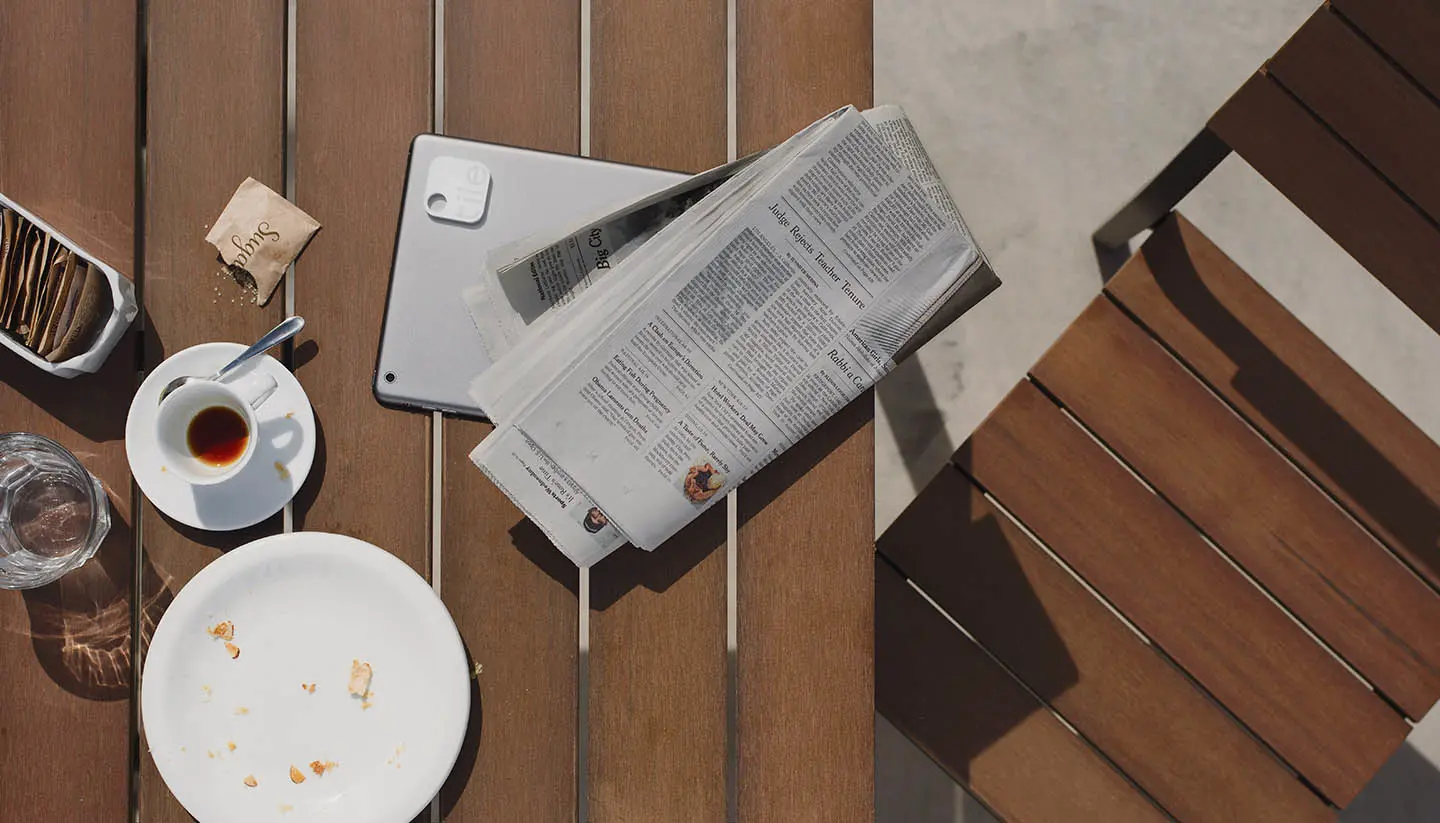 A Kindle with a Tile attached