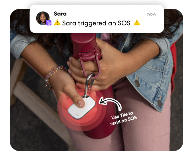 Person triggering an SOS alert by pressing a Tile Pro