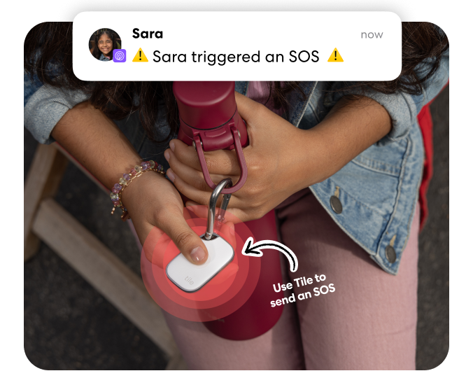 Person triggering an SOS alert by pressing a Tile Pro