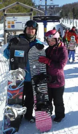 Two snowboarder with Tiles on their snowboards