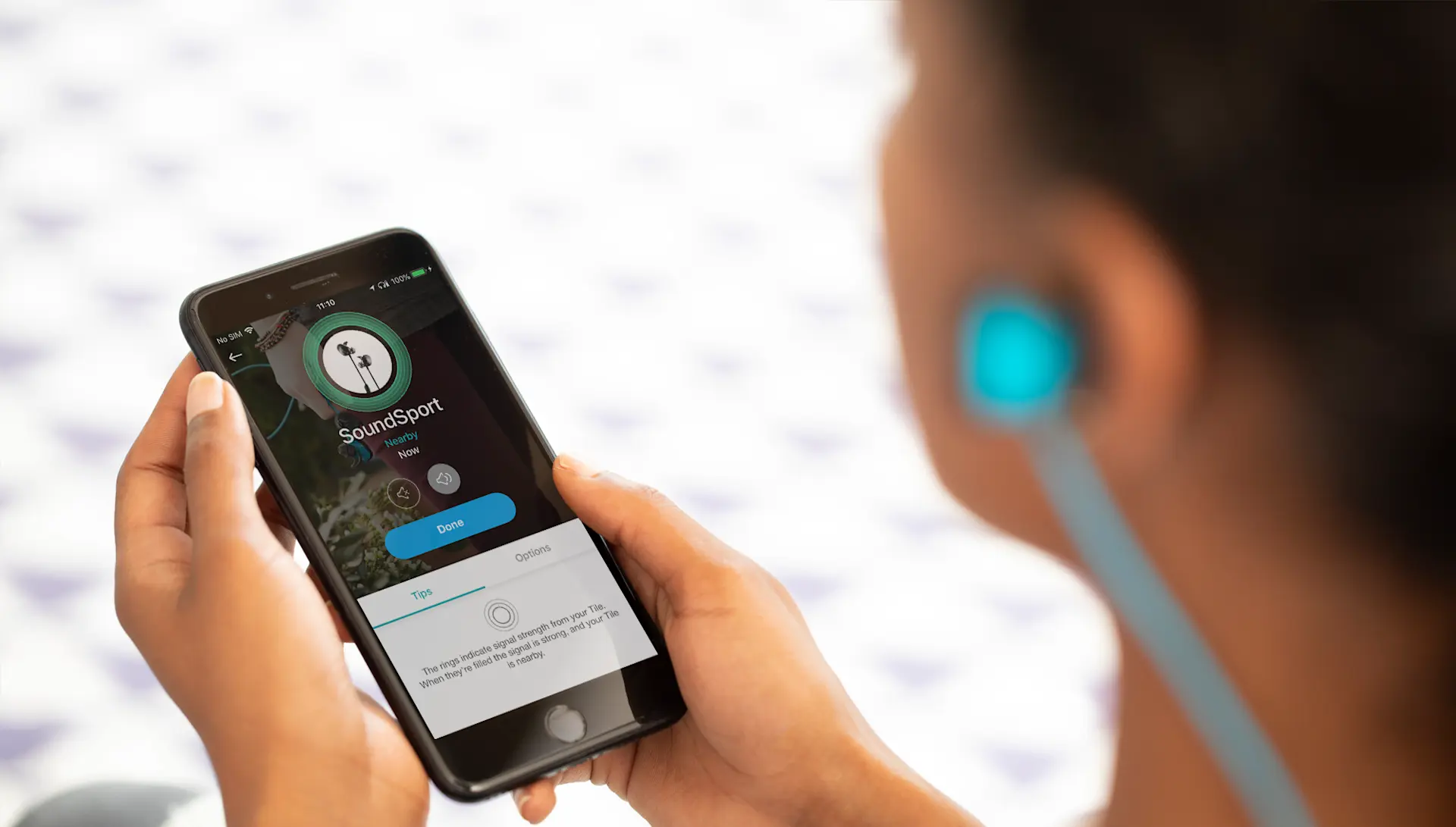 A person finding their earbuds on the Tile app