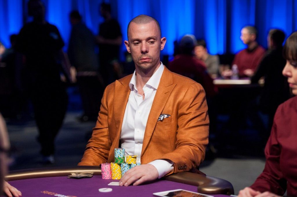 Matt Berkey playing poker in an orange suit