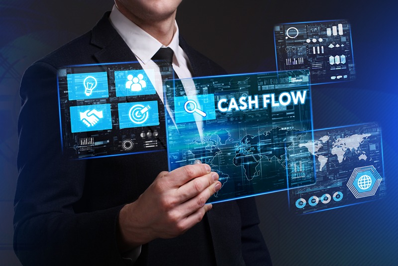 businessman_touching_virtual_cash_flow_icon_with_holographic_financial_data_and_world_map_display