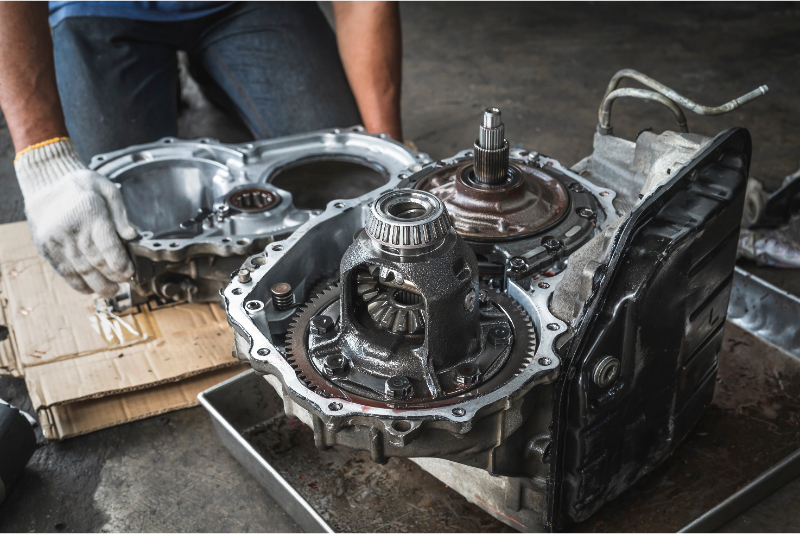 Mechanic_assembling_automotive_transmission_with_steel_gears