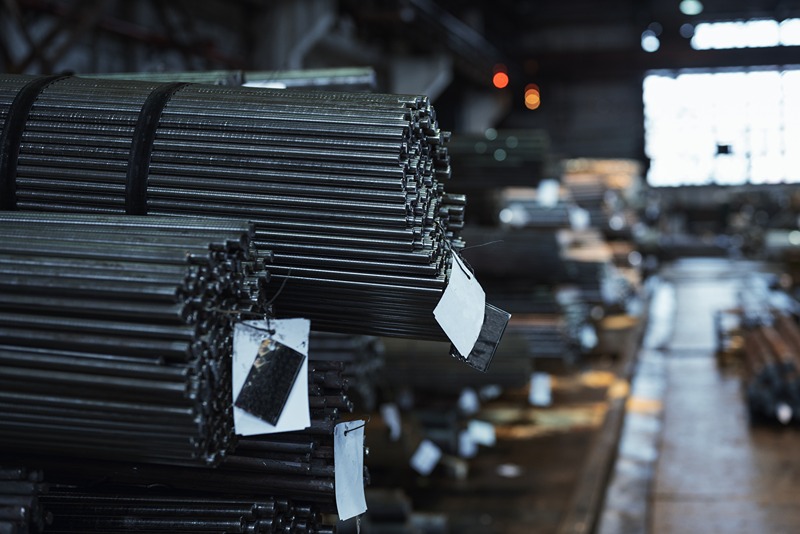 Close_up_of_TMT_bars_in_a_factory_setting_with_industrial_lighting_in_the_background