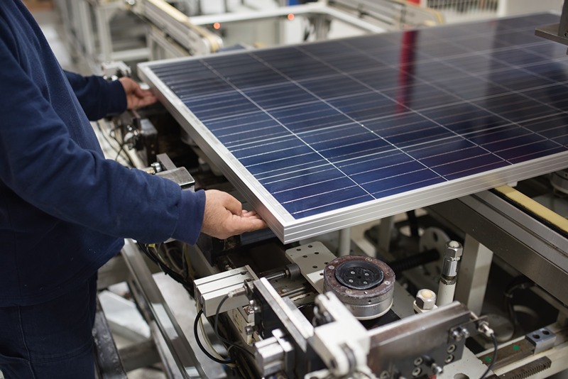 production_of_solar_panels,_man_working_in_factory.