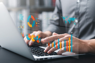 hands_typing_on_a_laptop_with_virtual_graphs_and_charts_displayed