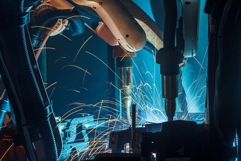 robotic_arms_welding_an_automobile_frame_in_a_high_volume_manufacturing_plant