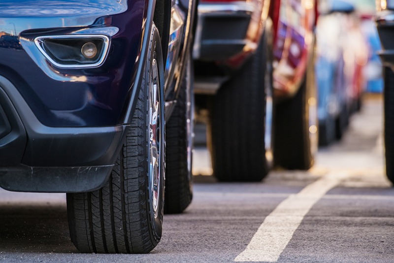 up_of_parked_cars_focusing_on_tires_and_front_headlights