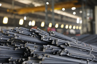 Stack_of_TMT_bars_in_a_warehouse_with_a_high_ceiling_and_ambient_lighting.