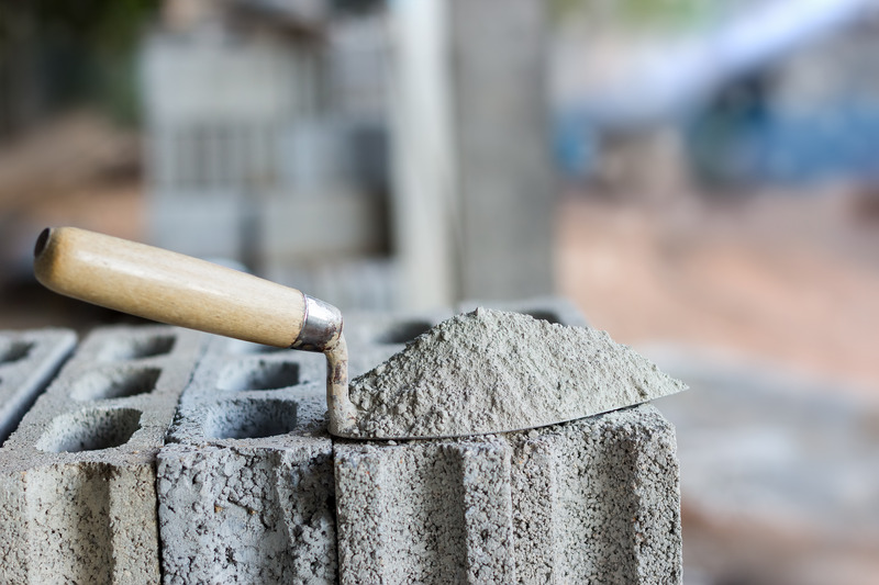 Cement_or_mortar,_Cement_powder_with_a_trowel_put_on_the_brick_for_construction_work.