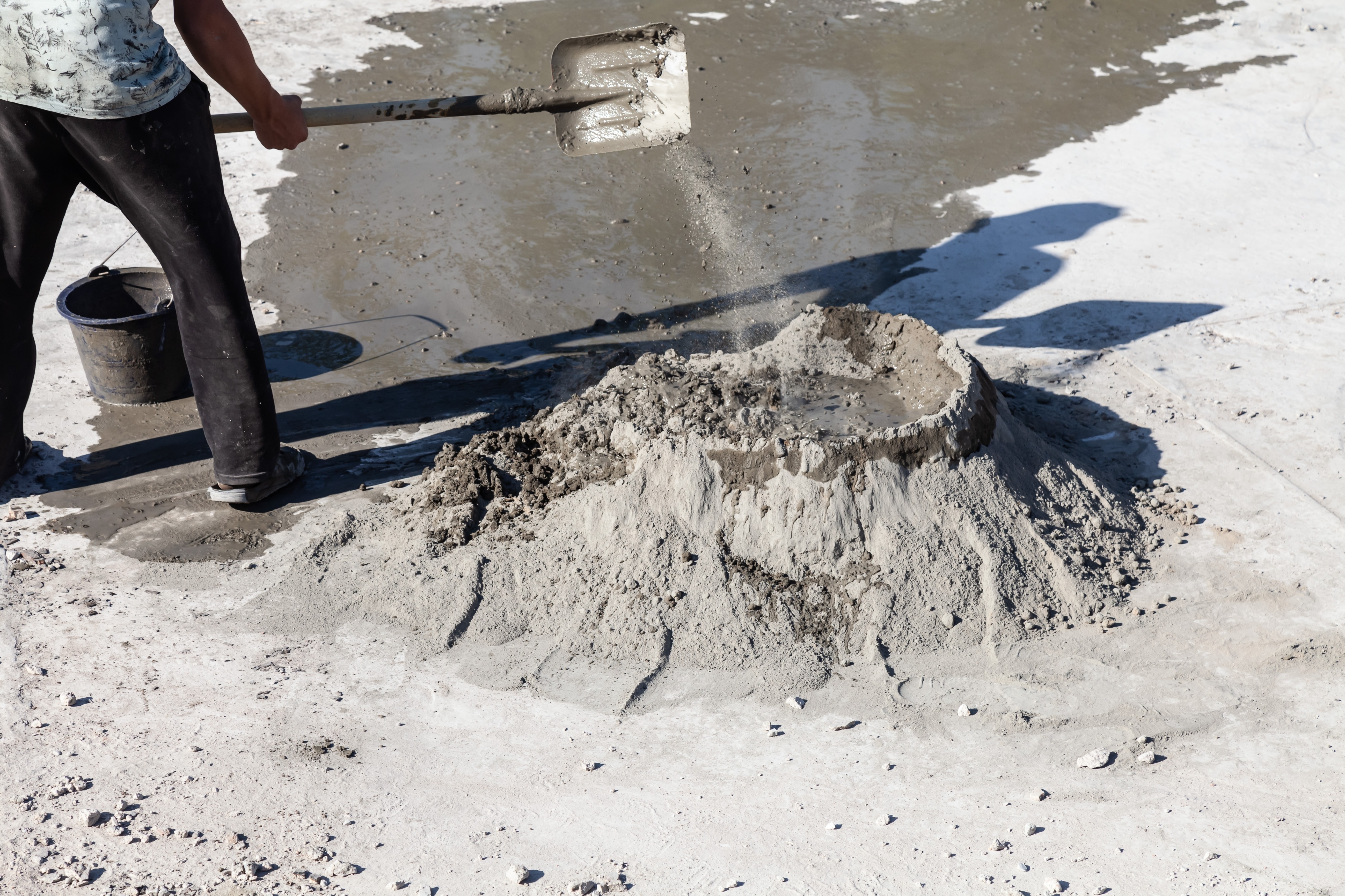 construction_worker_mixing_cement_and_aggregate_on_the_ground