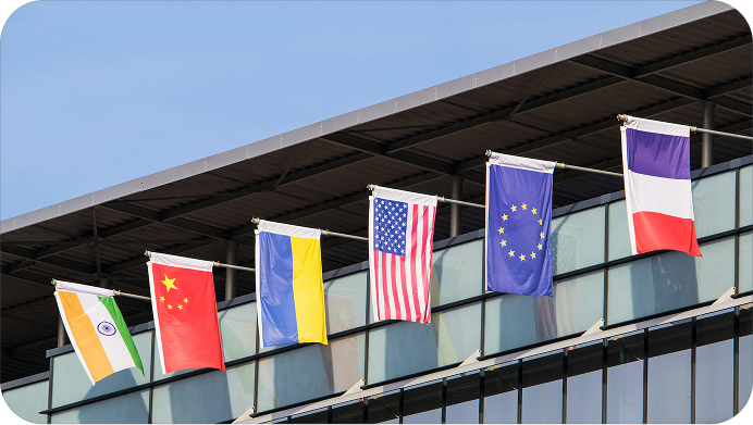 Exterior of a building with flags of different countries and regions extending from the roof