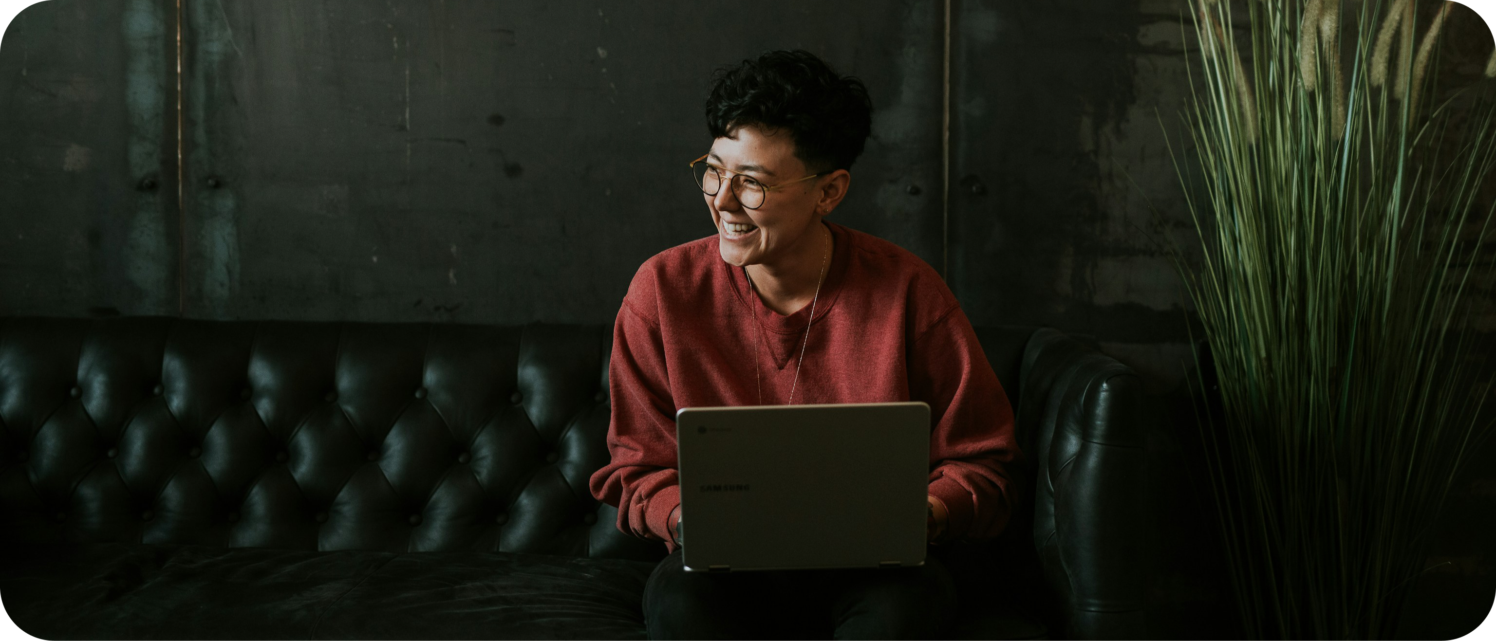 Person at keyboard smiling and looking to the left