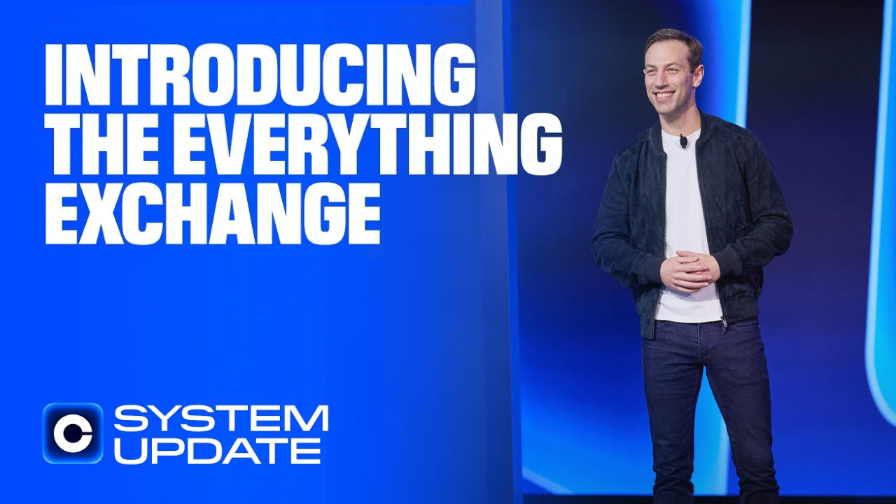 Coinbase's Head of Consumer onstage during System Update event with a headline next to him that says "Introducing the Everything Exchange"