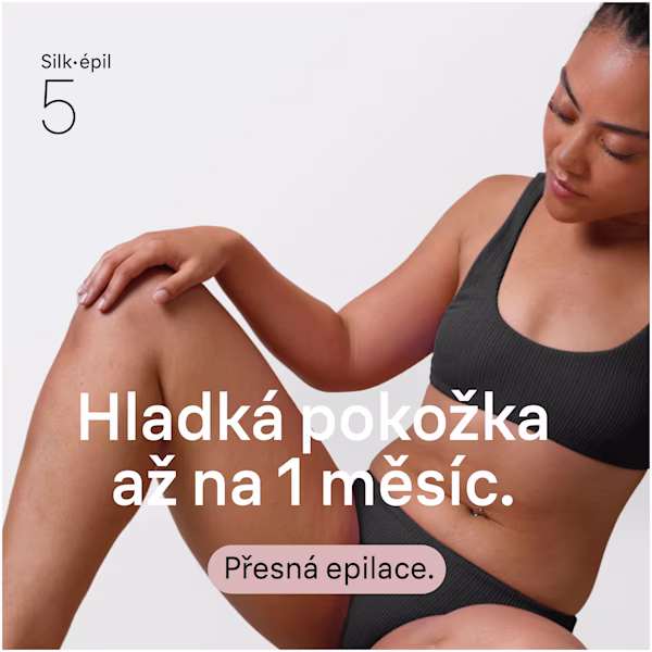 Snímek spokojené ženy, která sedí na podlaze a dívá se na své holeně a lýtka. Snímek spokojené ženy, která sedí na podlaze a dívá se na své holeně a lýtka.