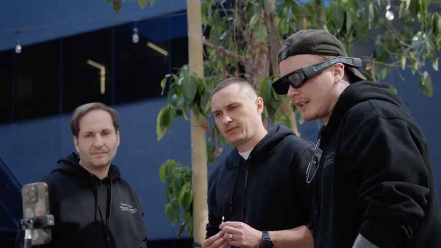 A group of people wearing smart glasses looking at a screen.