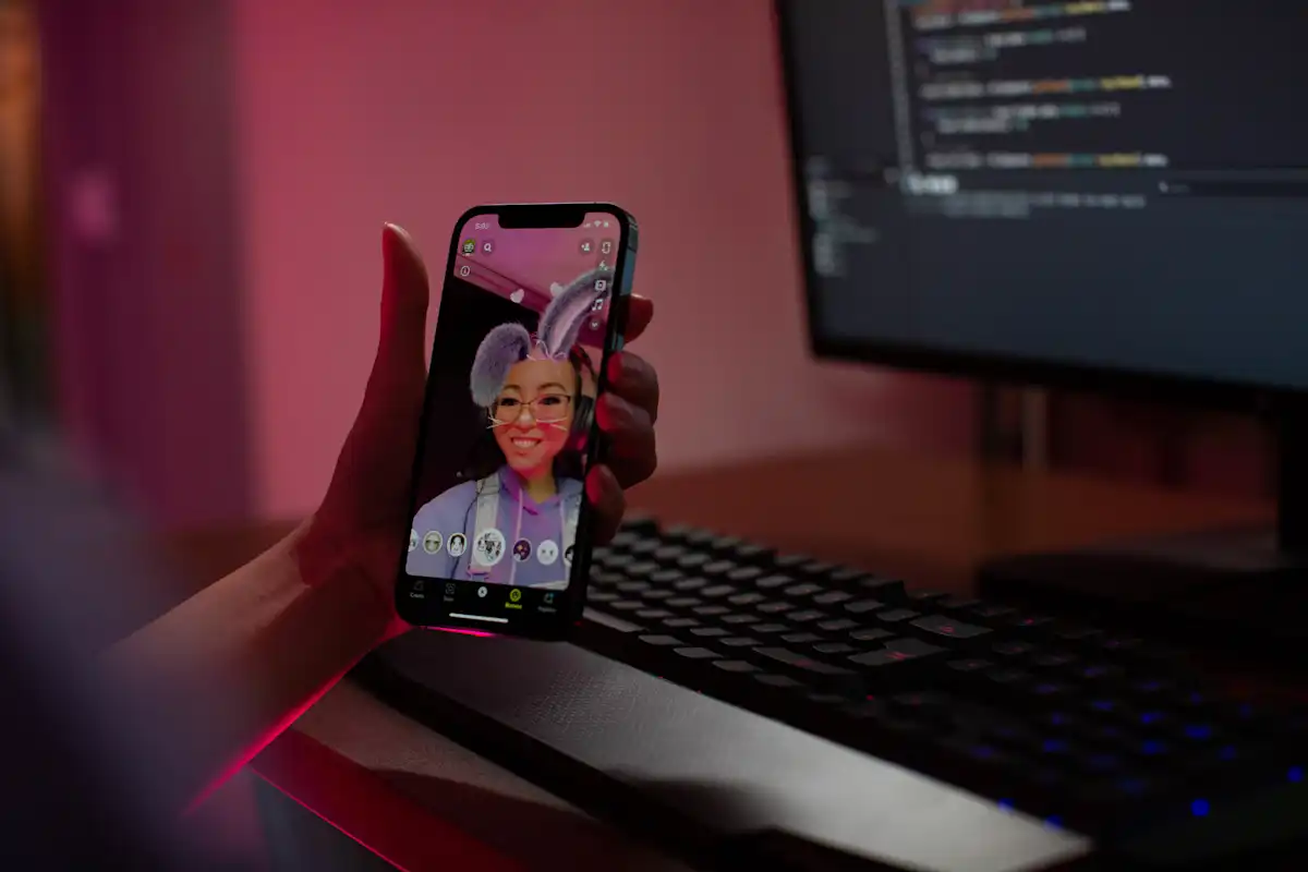 Image of a person trying a Lens on Snapchat and using Lens Studio.
