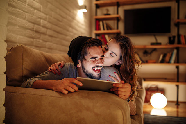 happy couple tablet couch