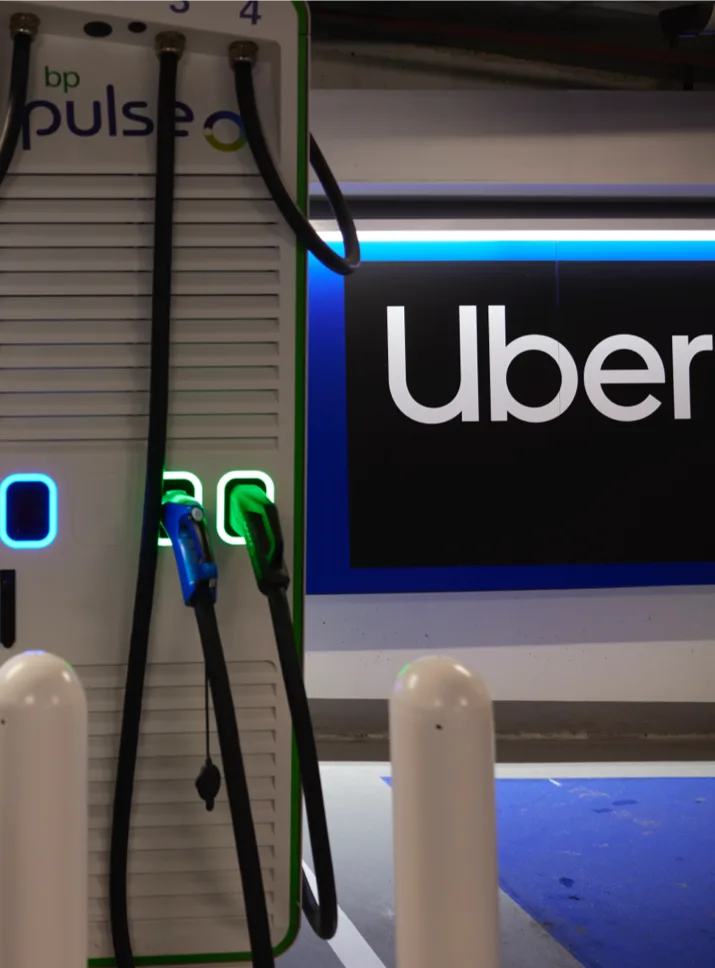 The uber logo sits behind a bp pulse EV charger.