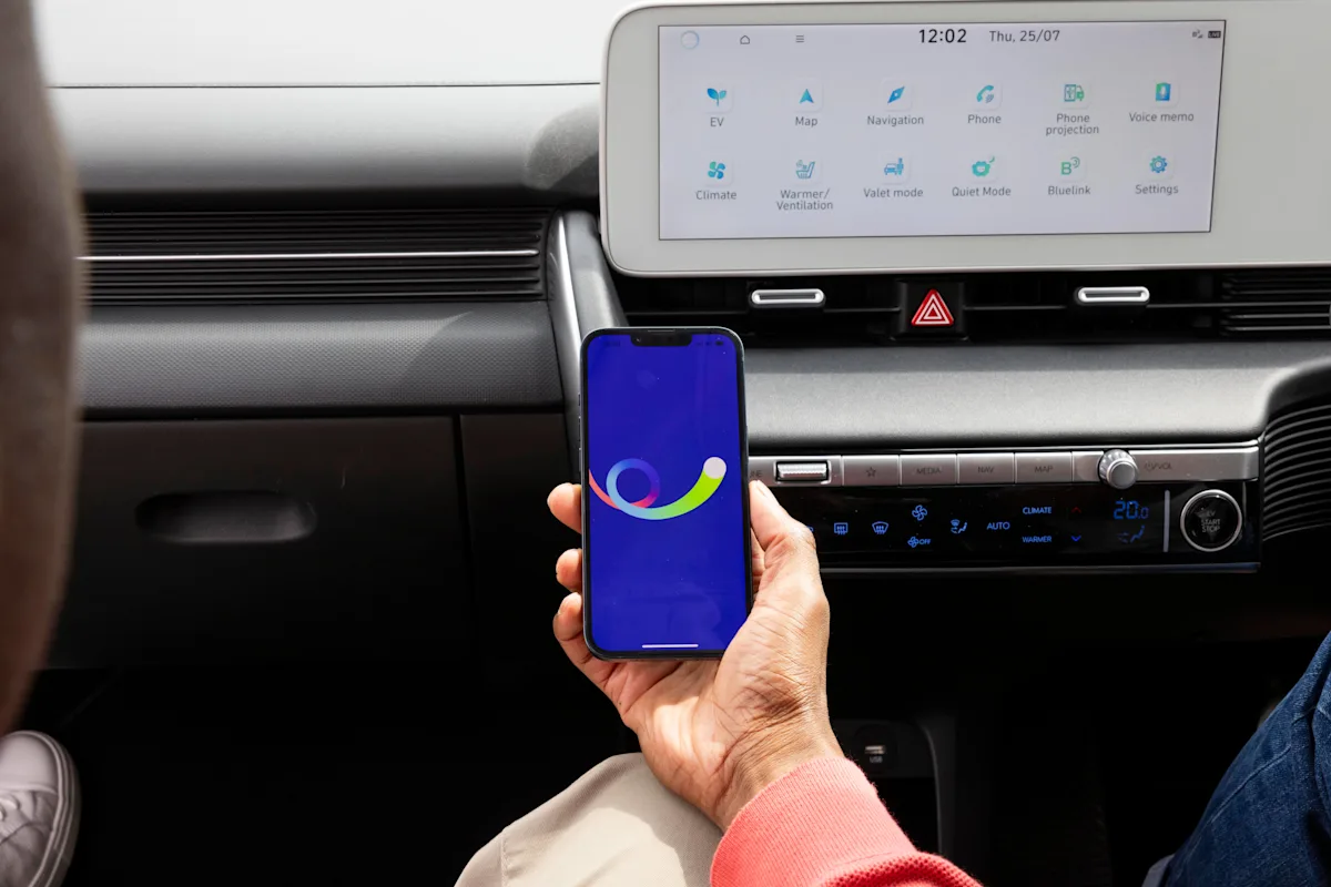 A hand holds a phone which is opening the bp pulse app.