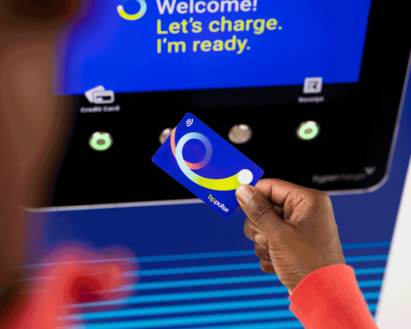 A customer taps their bp pulse card to a bp pulse chargers payment terminal. 