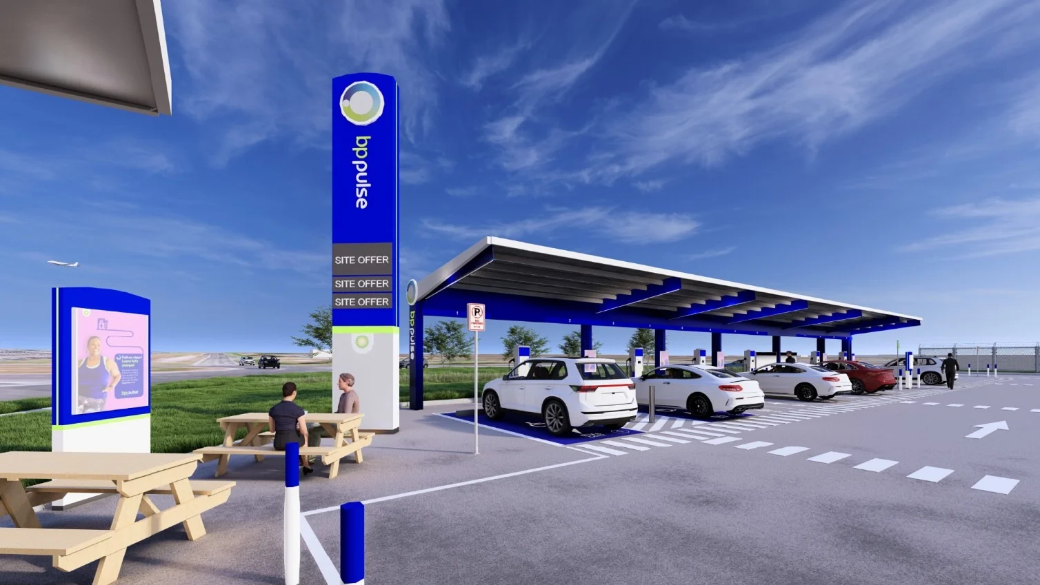 A visualisation of a bp pulse EV charging site with multiple covered charging bays, parked electric vehicles, and seating areas for drivers to relax.