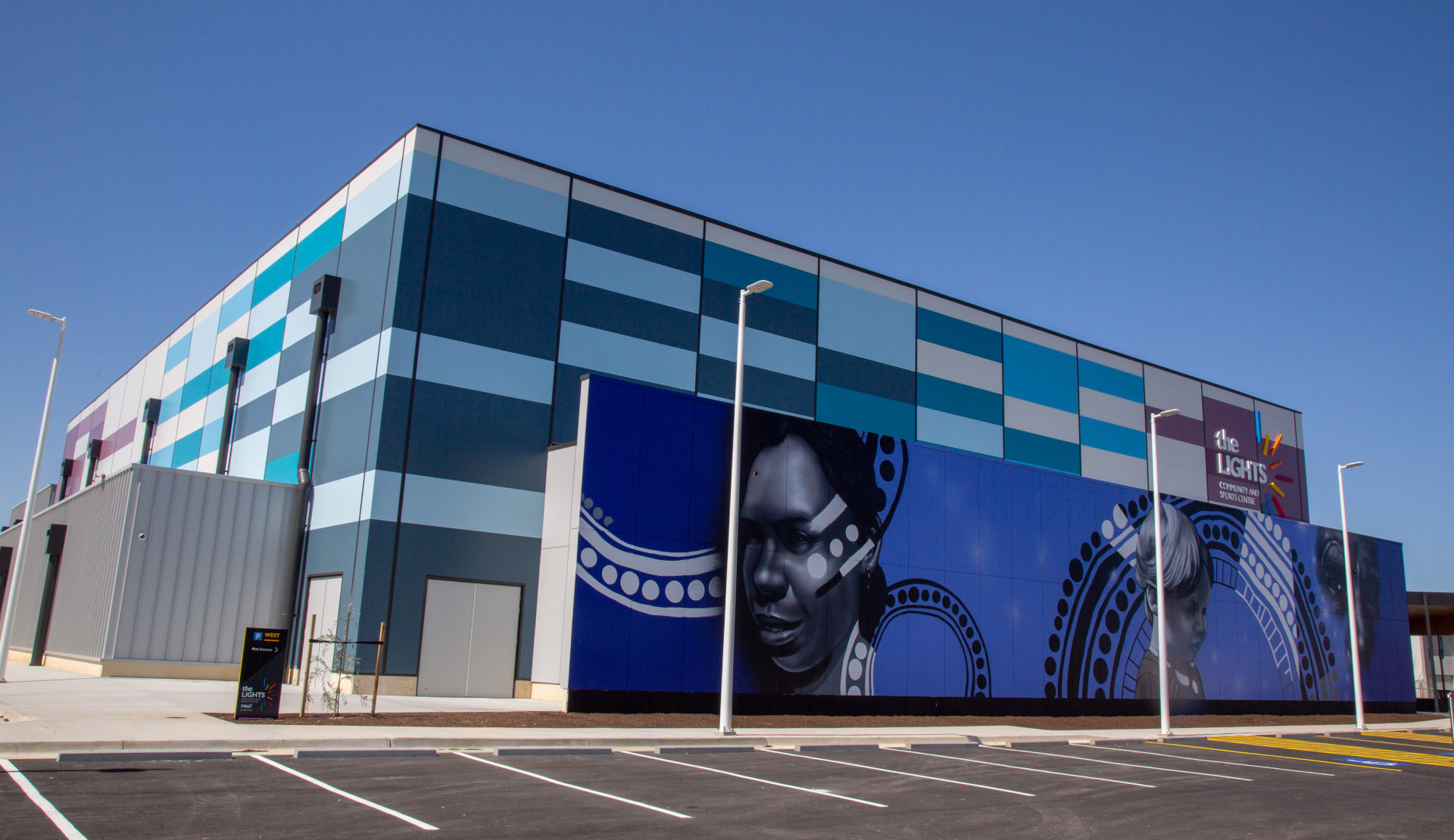 Mural on front of building with the aboriginal faces