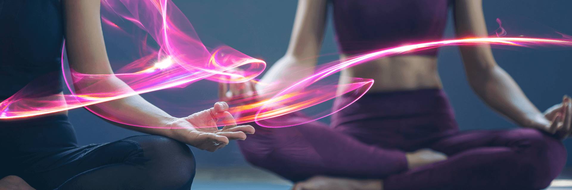 Two ladies are sitting in a yoga position