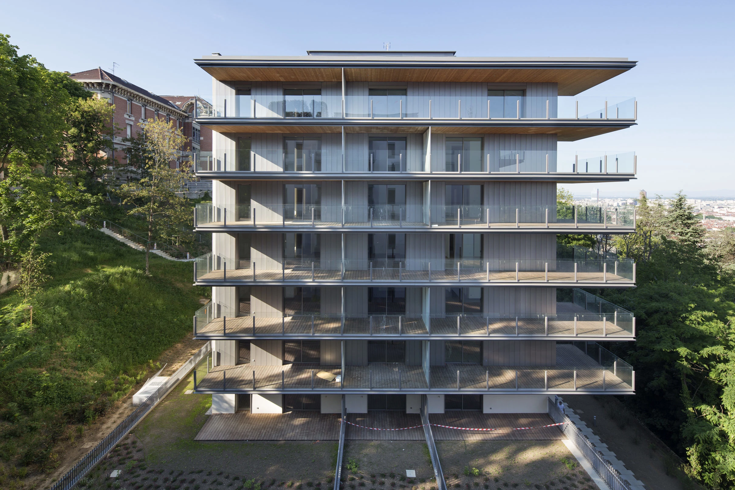 Ce vaste programme résidentiel intègre harmonieusement ses cinq résidences au paysage lyonnais. Les solutions TECHNAL apportent performance et flexibilité : coulissants LUMEAL pour des ouvertures généreuses et fenêtres SOLEAL pour une lumière naturelle inégalée, répondant aux exigences esthétiques et environnementales.