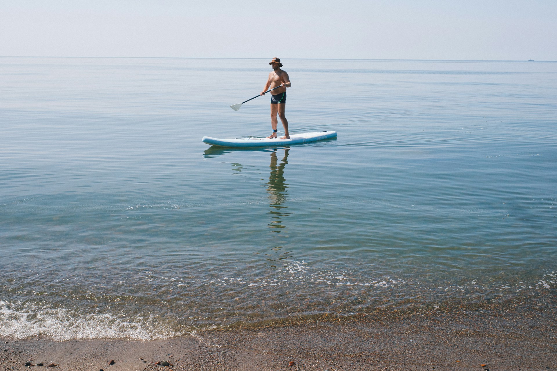 man paddleboarding | man paddleboarding