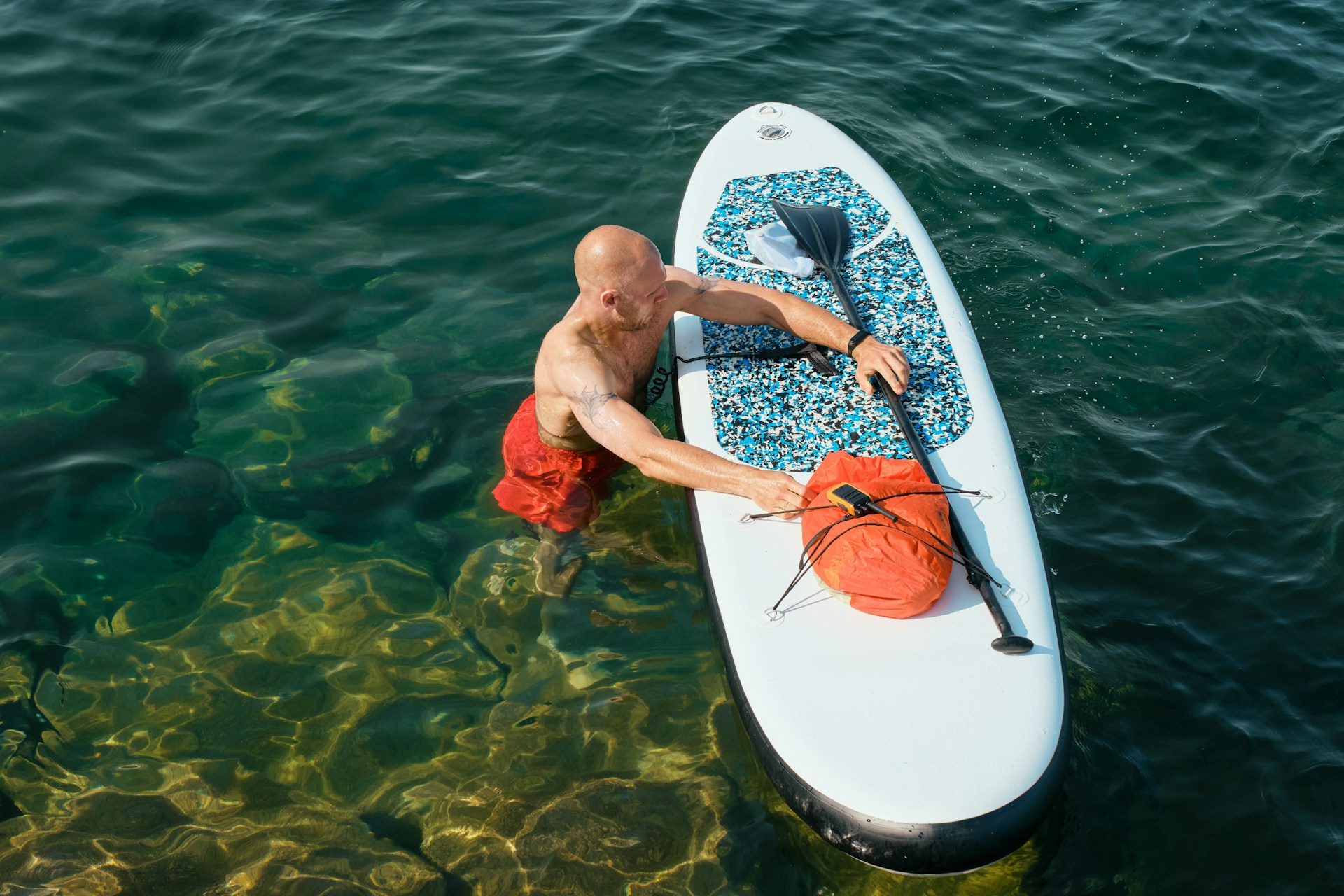 man paddleboarding | man paddleboarding