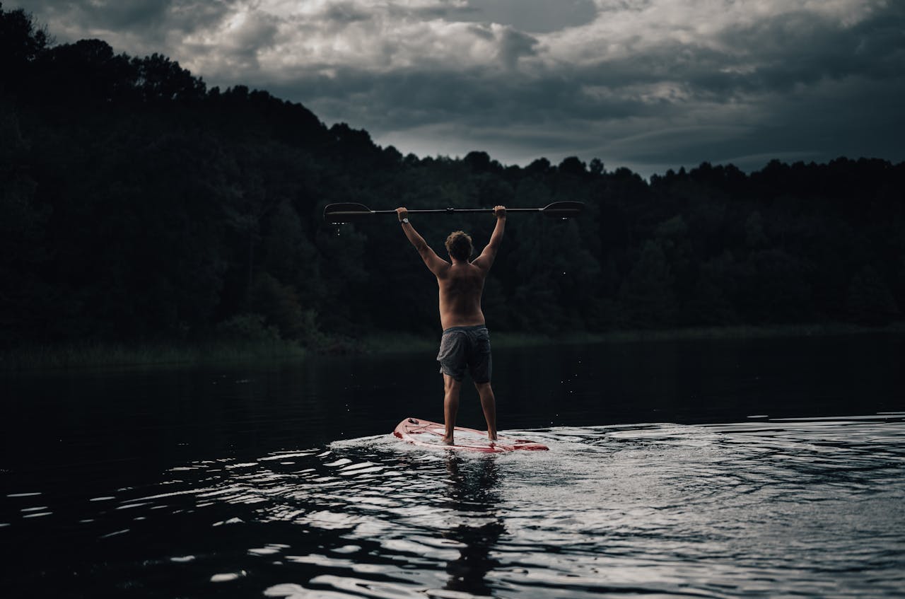 man paddleboarding | man paddleboarding