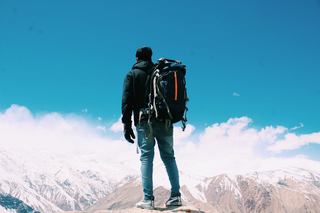 man standing on top of mountain | man standing on top of mountain