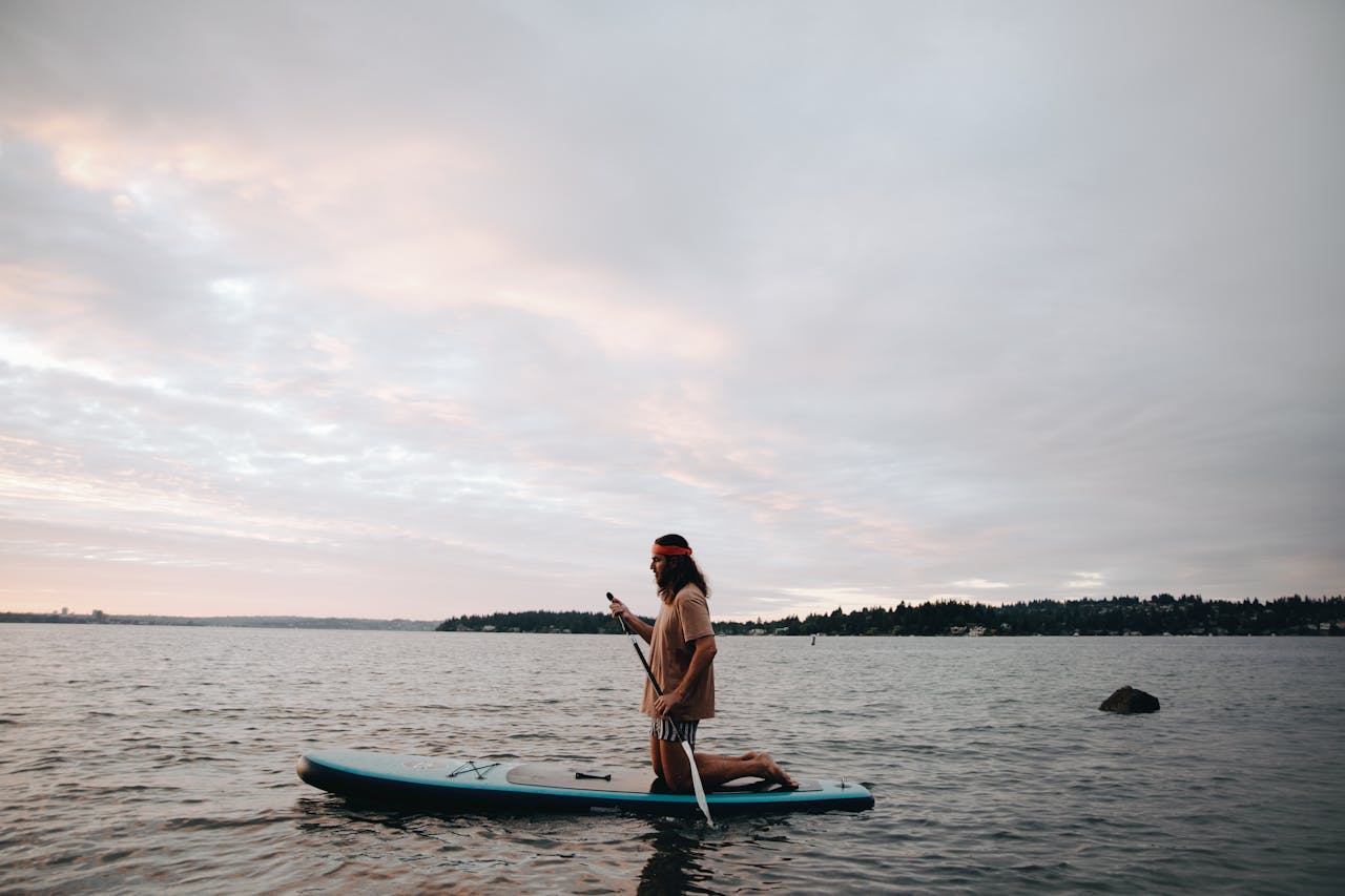 man paddleboarding | man paddleboarding